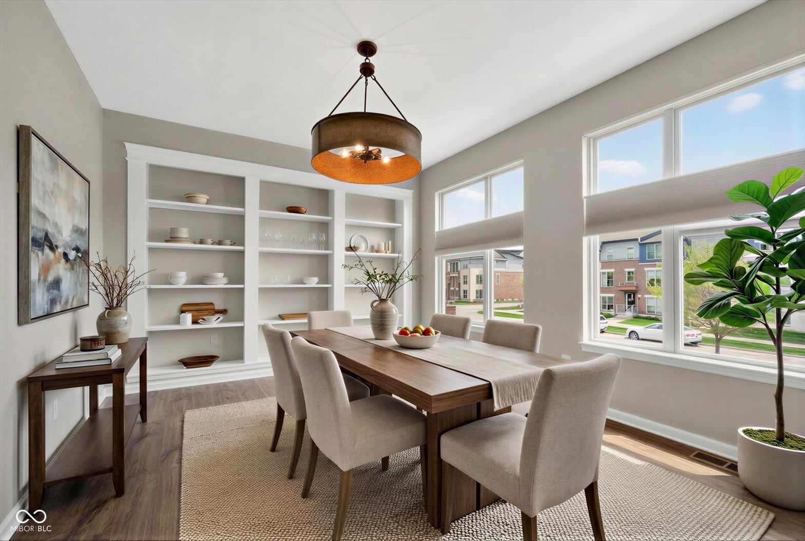 Bright dining room with built-in shelving and abundant natural light.