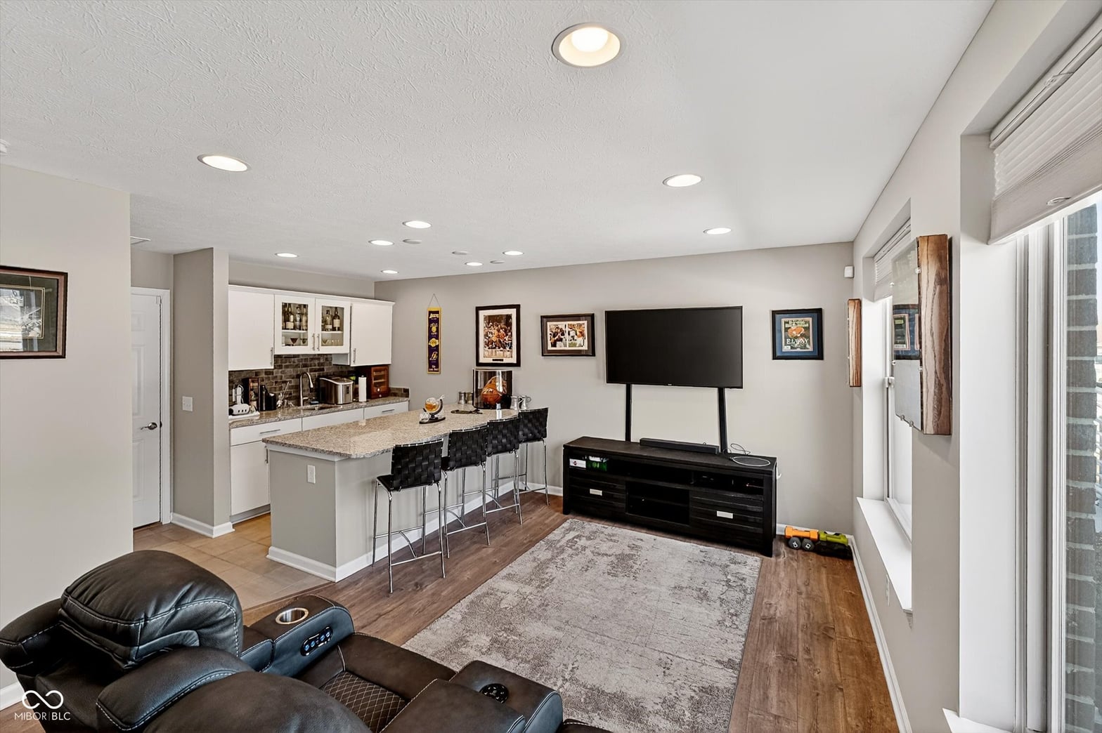 Open-concept family room with wet bar and kitchen pass-through.