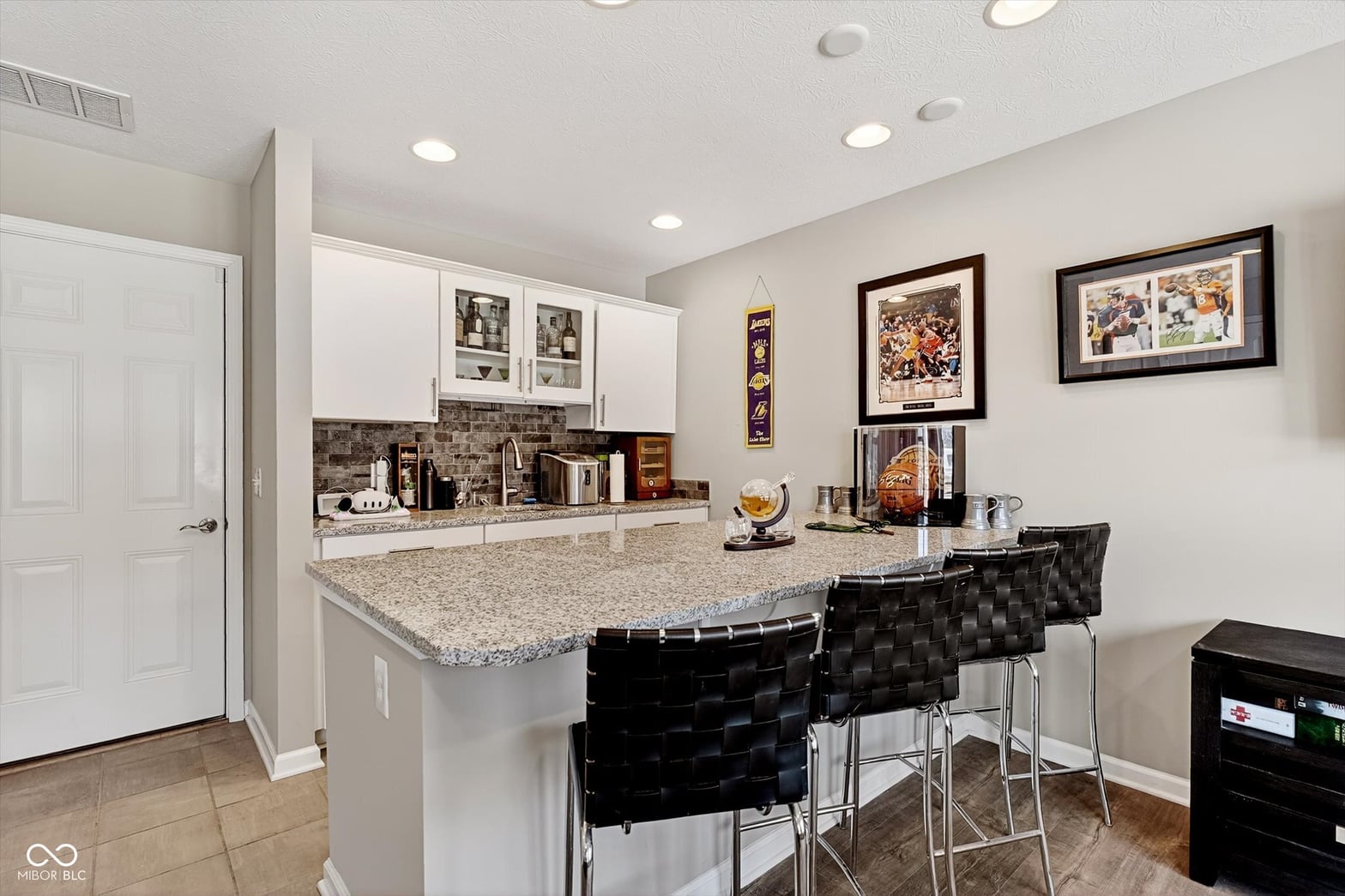Modern kitchen with granite island and updated appliances.