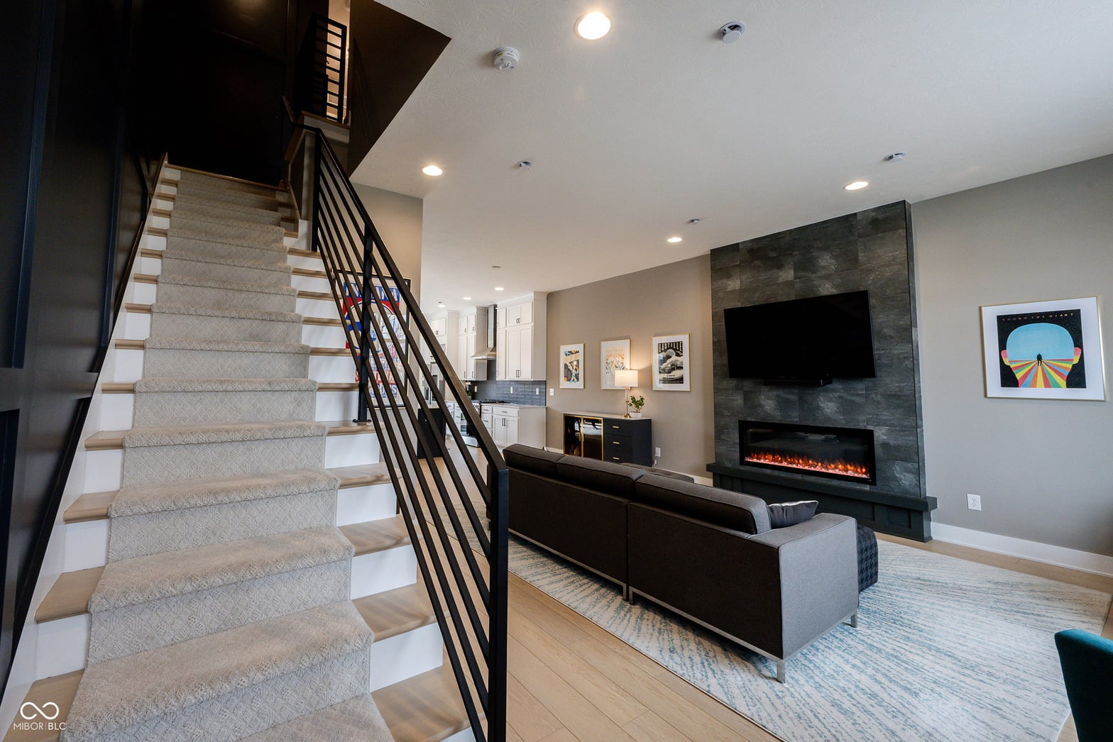 Modern family room with electric fireplace and entertainment setup.