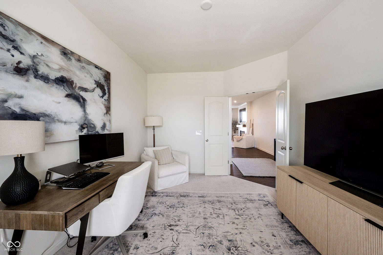 Spacious primary suite with sitting area and ensuite access.