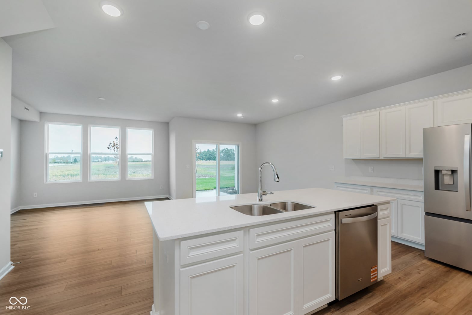 Bright modern kitchen with island and rural views.