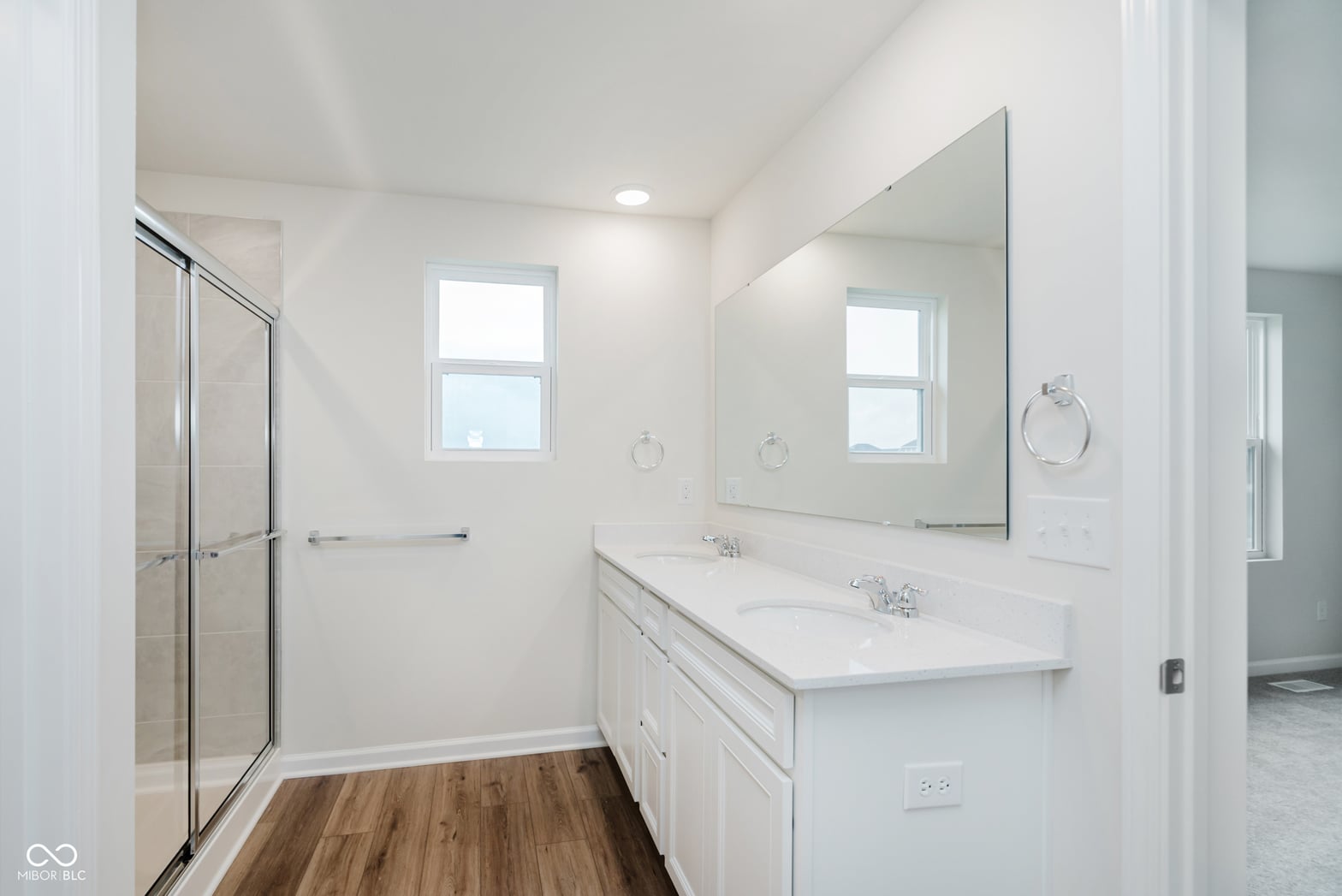 Luxurious primary bath with dual vanity and marble.