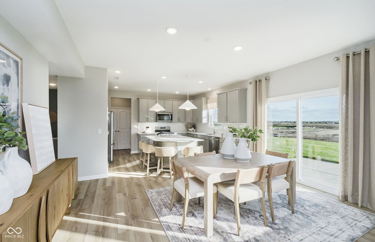 Bright open-concept dining and kitchen with countryside views.