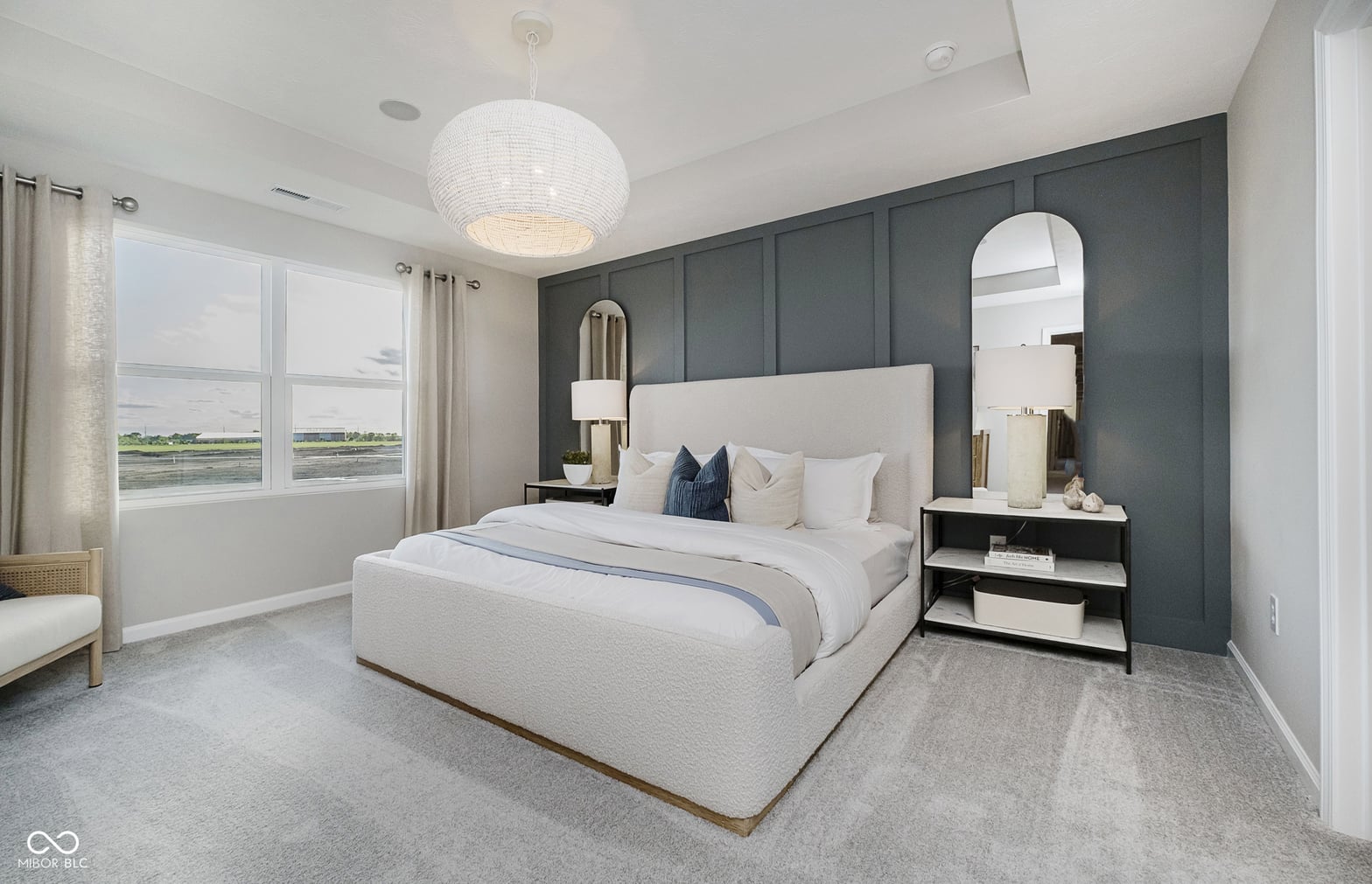 Luxurious primary bedroom with water views and modern design.