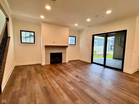 Family room at 9867 Bucklebury Lane, Carmel, IN — Bright new family room with fireplace and patio access.