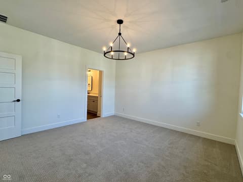 Primary bedroom at 9867 Bucklebury Lane, Carmel, IN — Spacious primary suite with en-suite bathroom access.