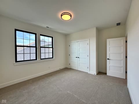 Bedroom at 9867 Bucklebury Lane, Carmel, IN — Bright bedroom with ample closet space and natural light.