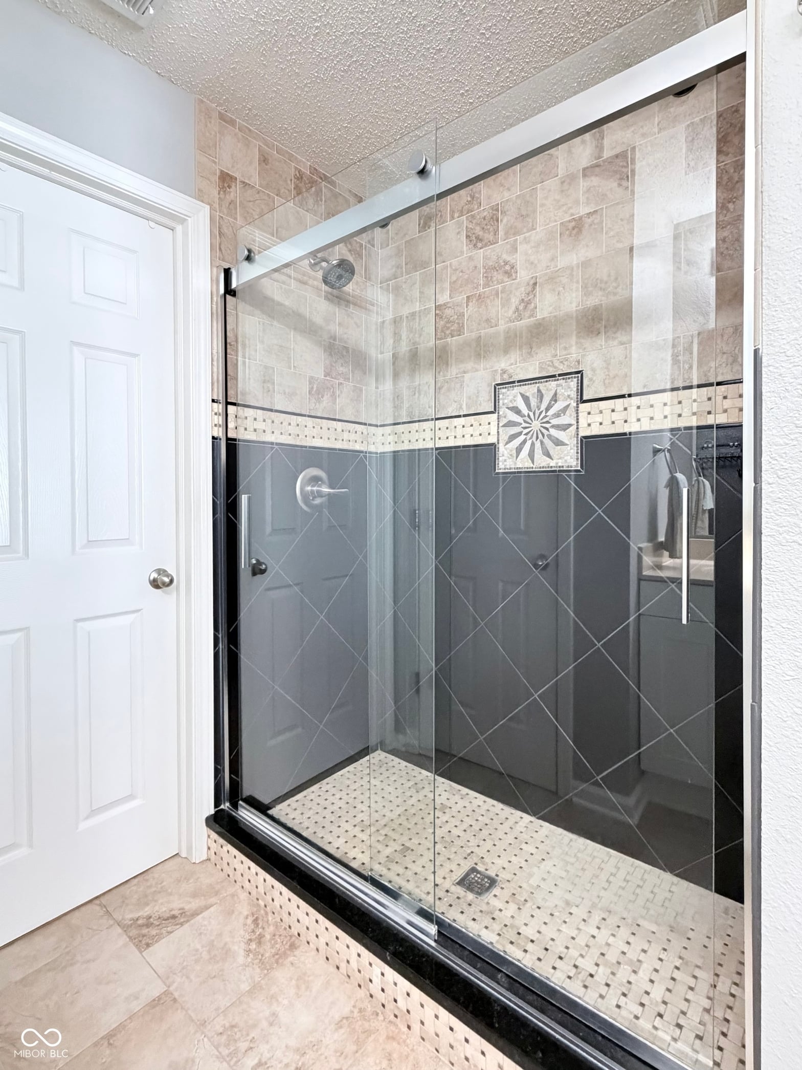 Luxurious walk-in shower with elegant tile design.