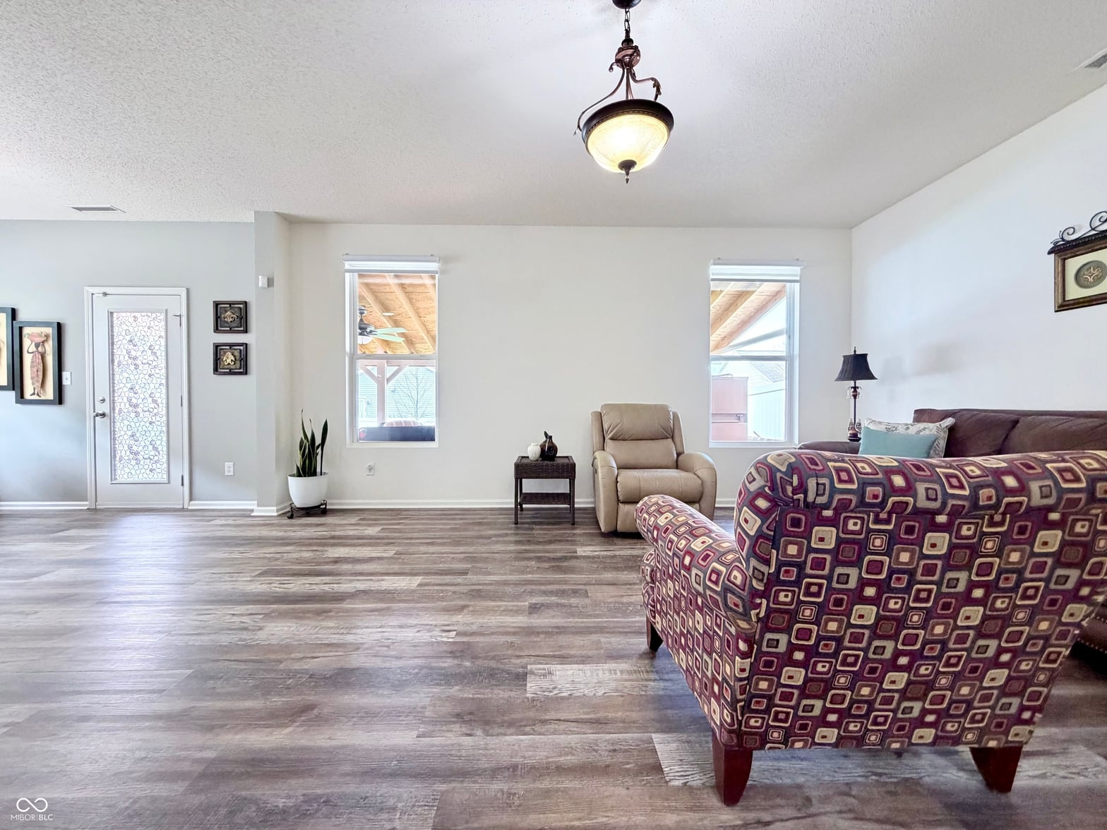 Spacious living room with hardwood floors and abundant natural light.