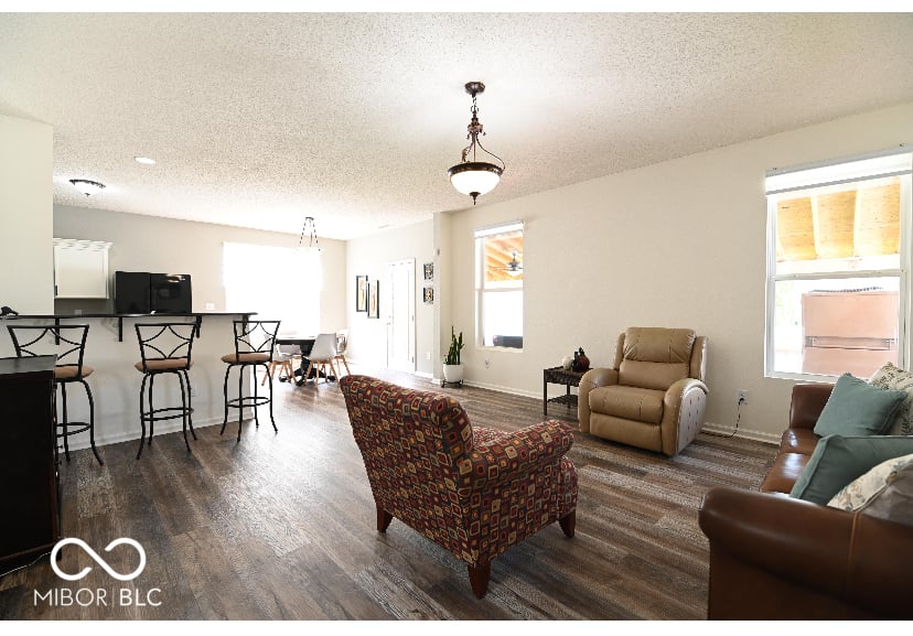 Spacious open-concept living with bar seating and natural light.