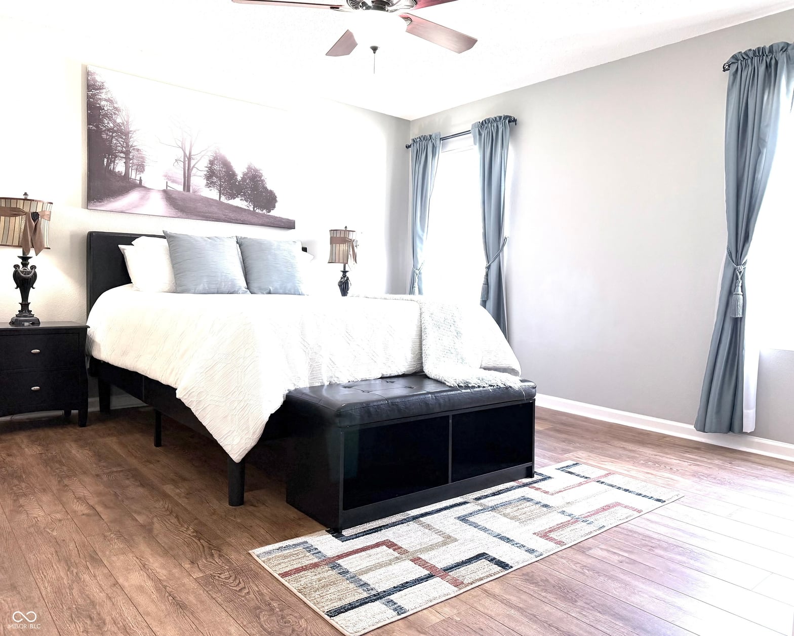 Spacious primary bedroom with hardwood floors and patio access.