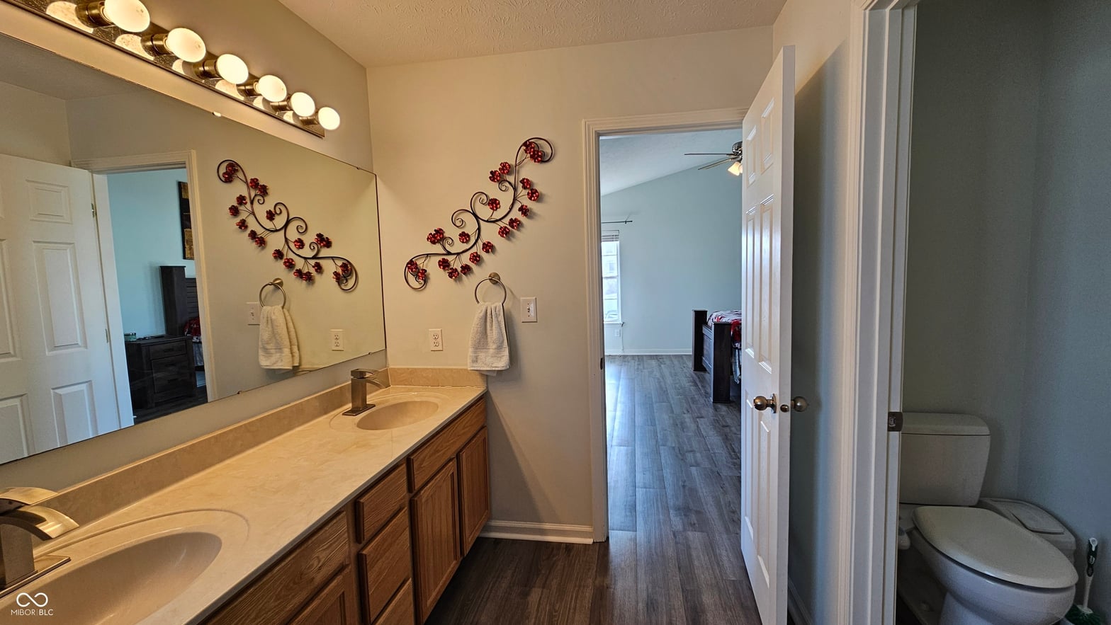Spacious primary bath with double vanity and elegant finishes.