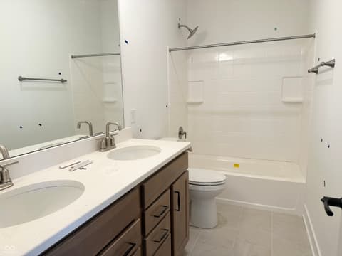 Primary bathroom at 19613 Wood Farm Place, Westfield, IN — Modern primary bath with double vanity and frameless shower.