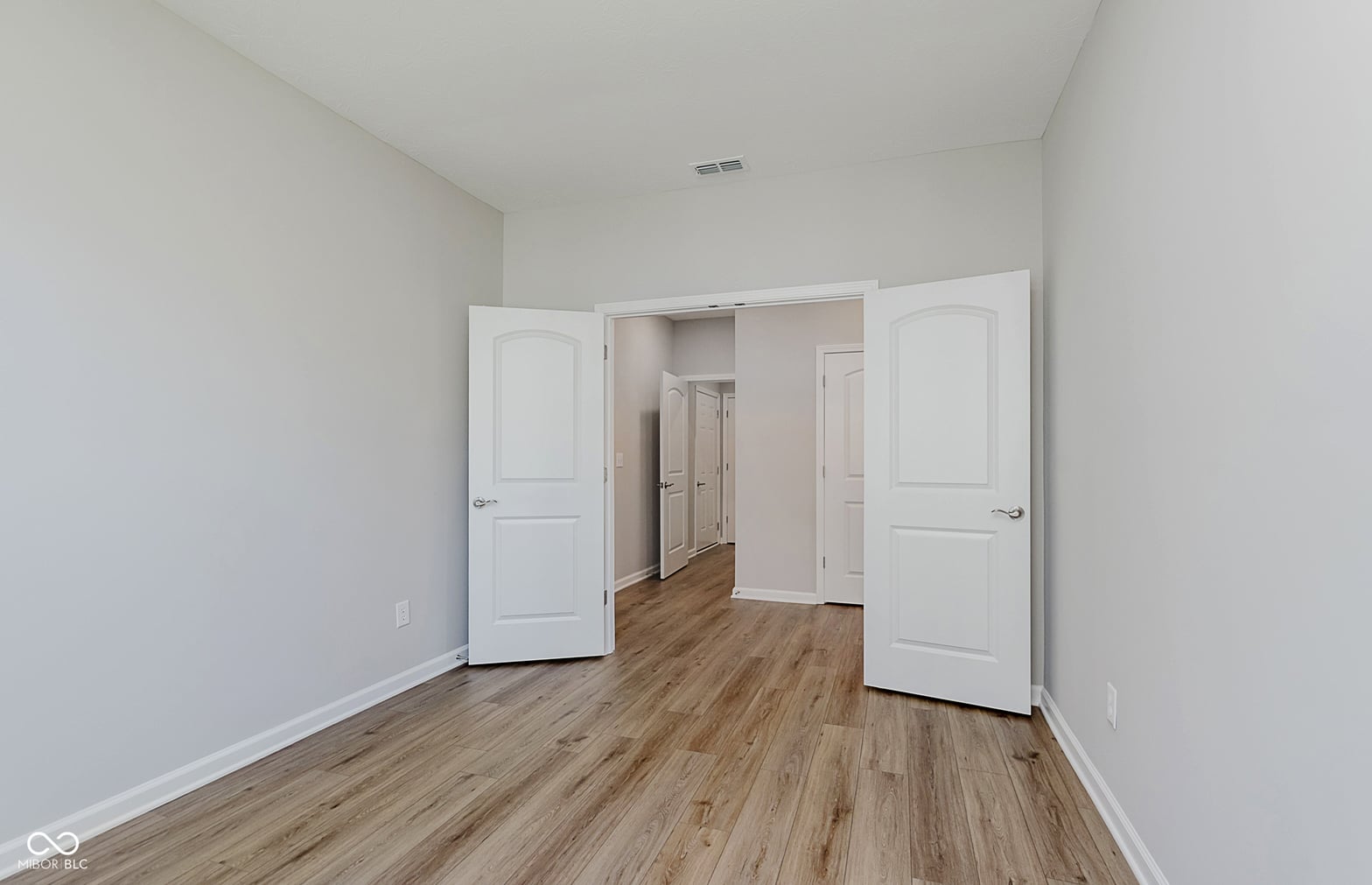Spacious primary bedroom with walk-in closet and modern finishes.