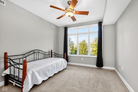 Bedroom at 20971 Shoreline Court, Noblesville, IN — Bright bedroom with expansive windows and scenic views.