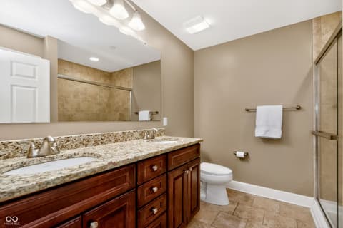 Primary bathroom at 20971 Shoreline Court, Noblesville, IN — Spacious primary bath with granite counters and dual sinks.