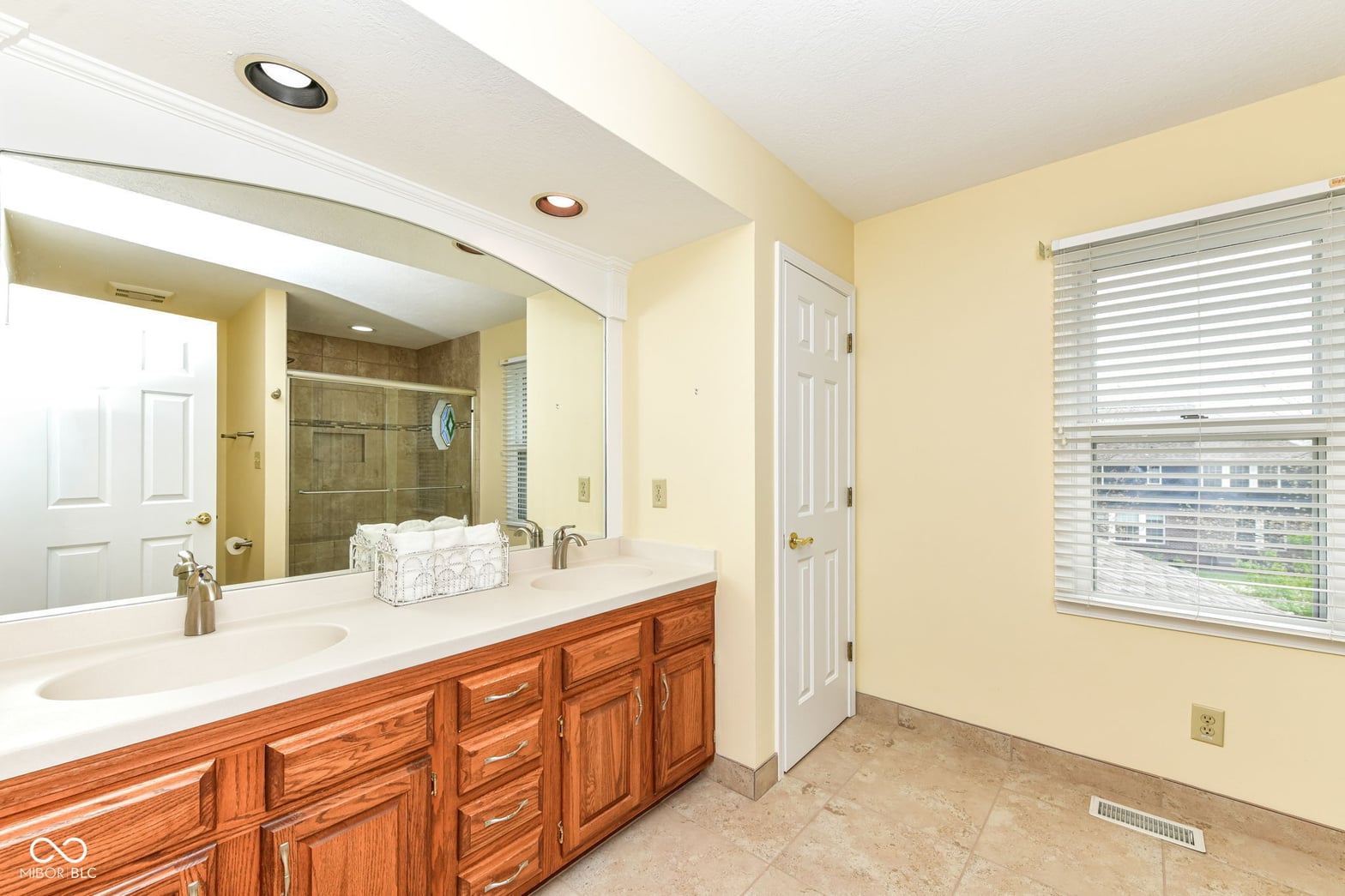 Spacious primary bath with double vanity and walk-in shower.