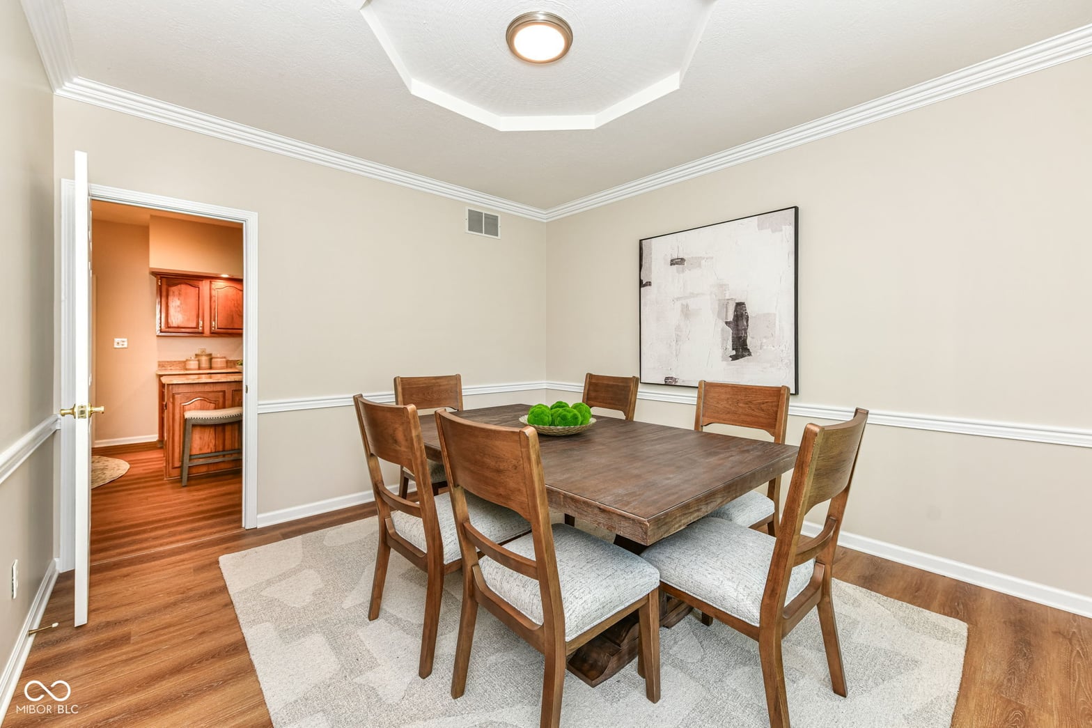 Elegant dining room with classic wainscoting and hardwoods.