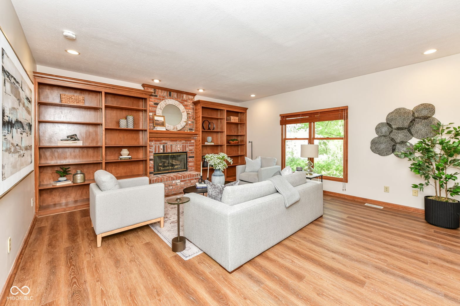 Bright living room with custom built-ins and fireplace.
