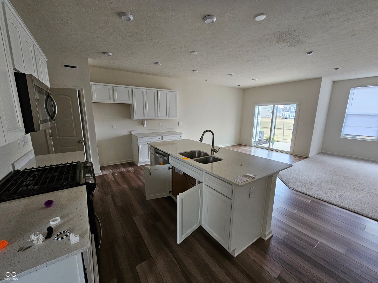 Bright open-concept kitchen with island and waterfront views.