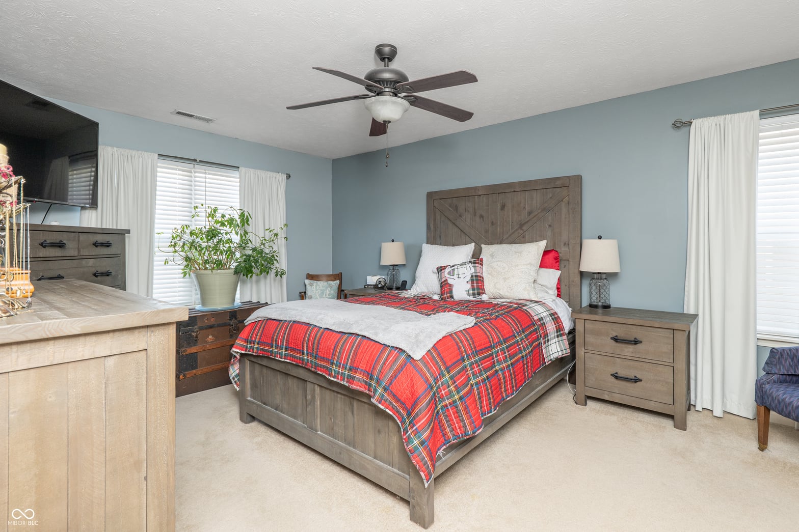 Bright farmhouse primary suite with patio access and ensuite.