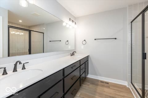 Primary bathroom at 434 Elite Street, Westfield, IN — Spa-like primary bath with dual vanity and walk-in shower.