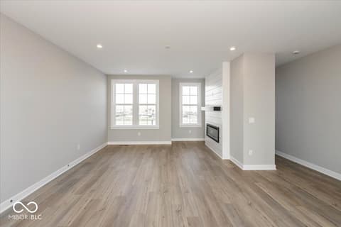 Living room at 434 Elite Street, Westfield, IN — Bright modern living space with fireplace and large windows.