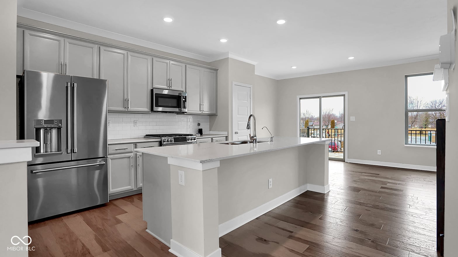 Bright modern kitchen with stainless appliances and island.