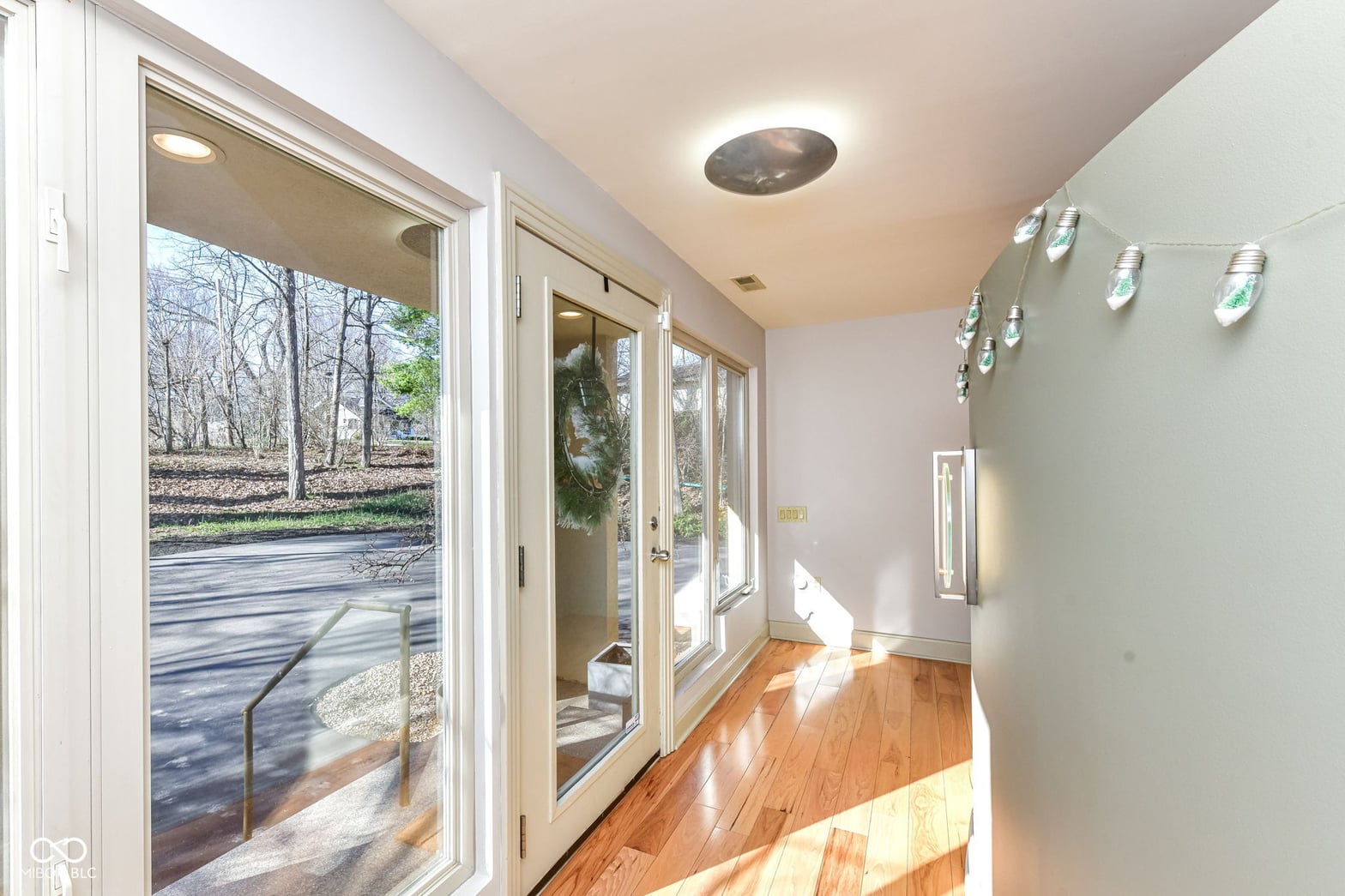 Bright waterfront transition space with expansive glass doors.