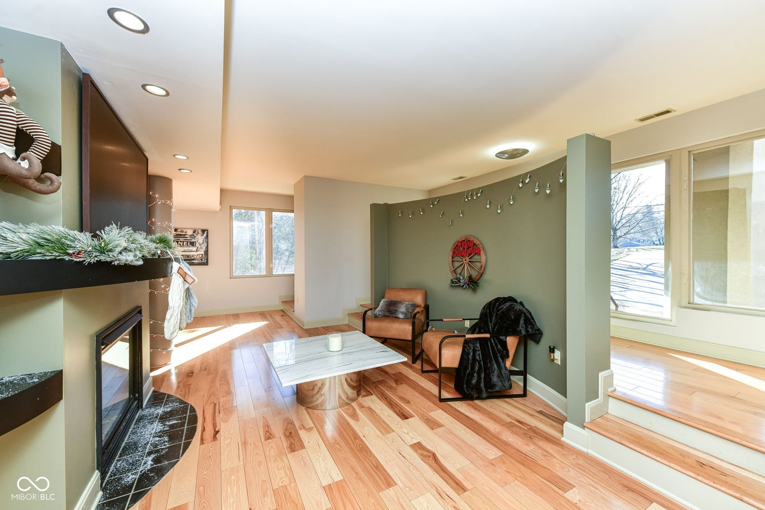 Bright family room with fireplace and abundant natural light.