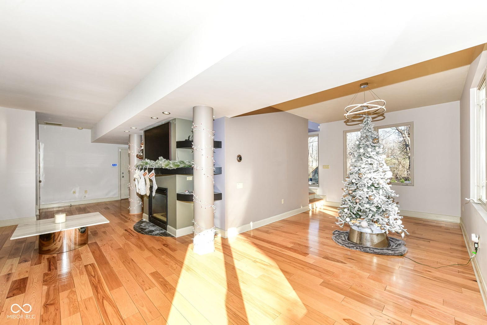 Bright, modern living space with soaring ceilings and hardwood floors.