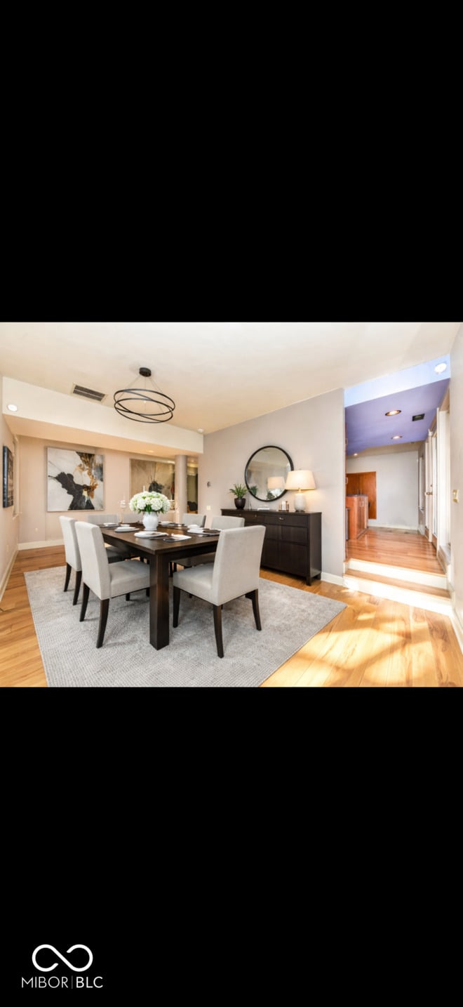 Bright contemporary dining room with hardwood floors and natural light.