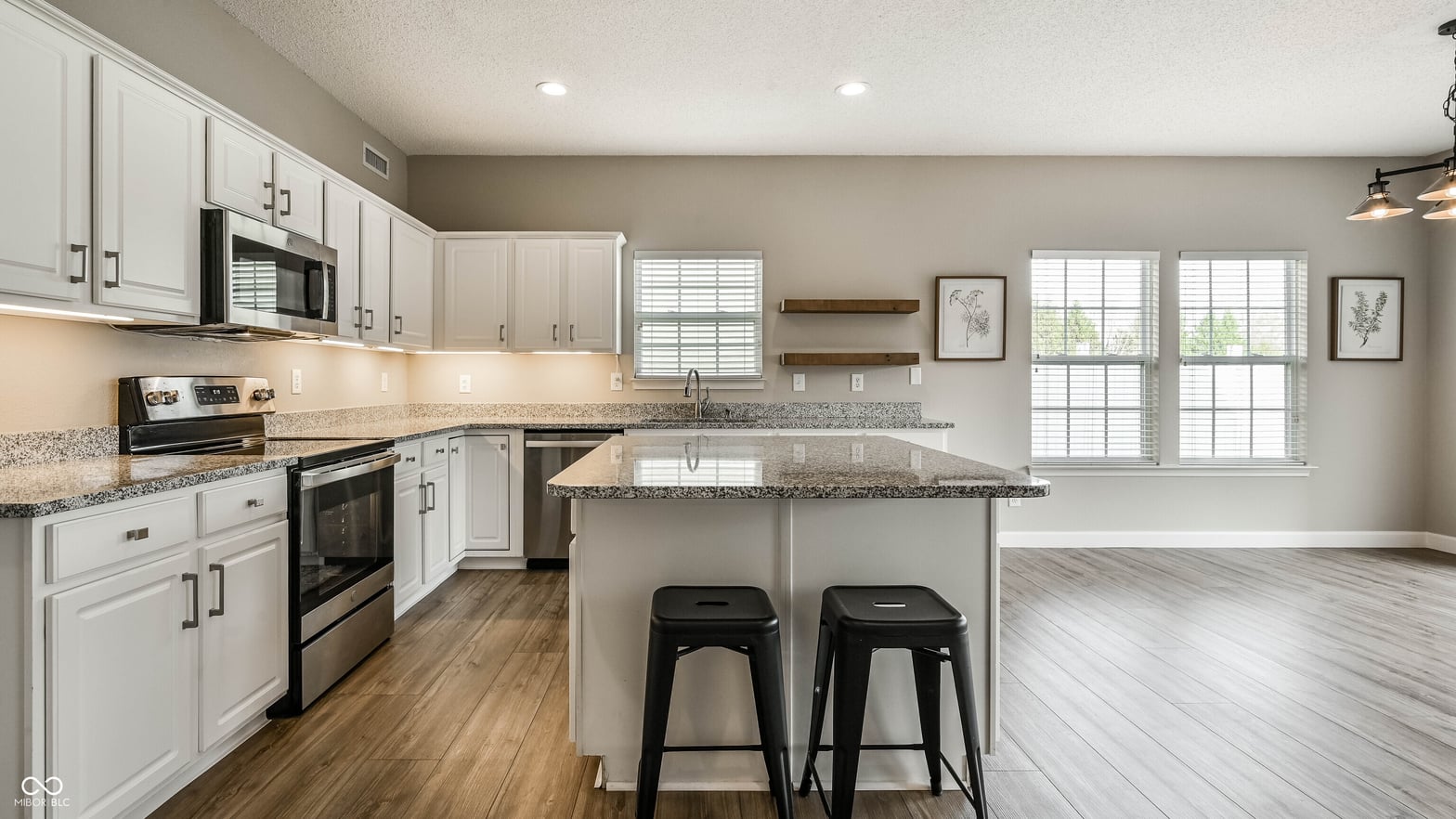 Bright updated kitchen with granite island and ample counter space.