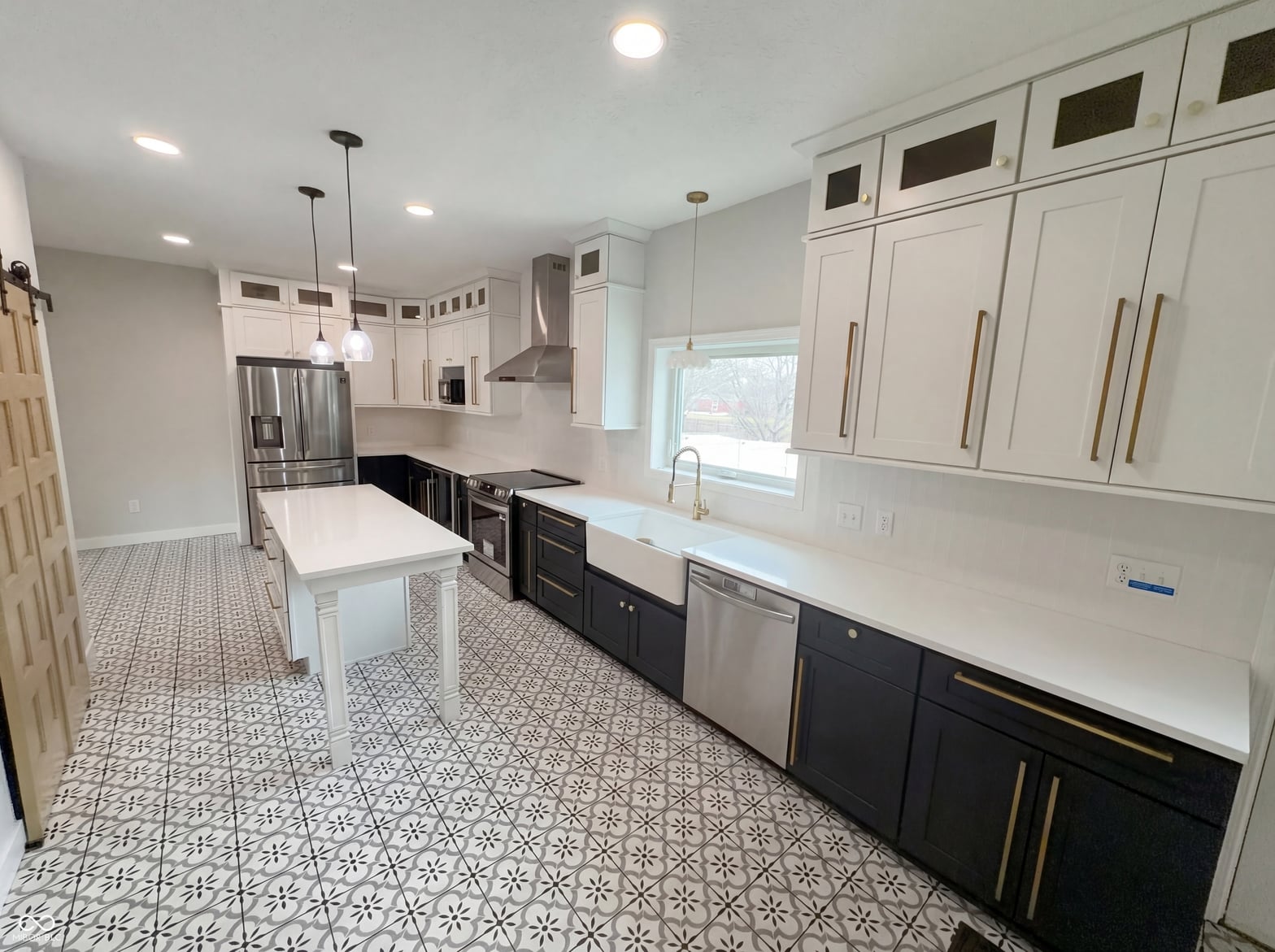 Newly renovated kitchen with mixed cabinetry and quartz counters.