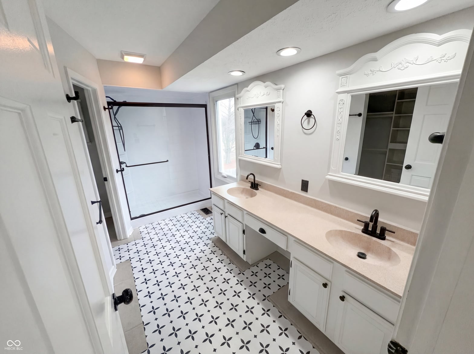 Luxurious primary bath with dual vanity and updated fixtures.