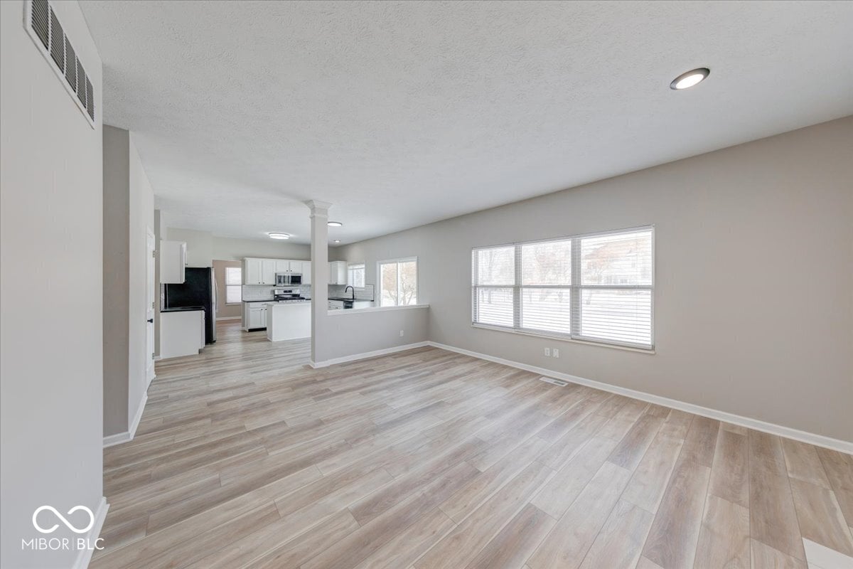 Bright open-concept living with hardwood floors and natural light.