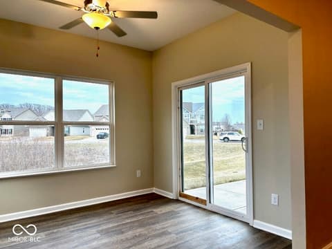 Family room at 9789 Mystic Sun Court, Fishers, IN — Bright room with abundant natural light and patio access.