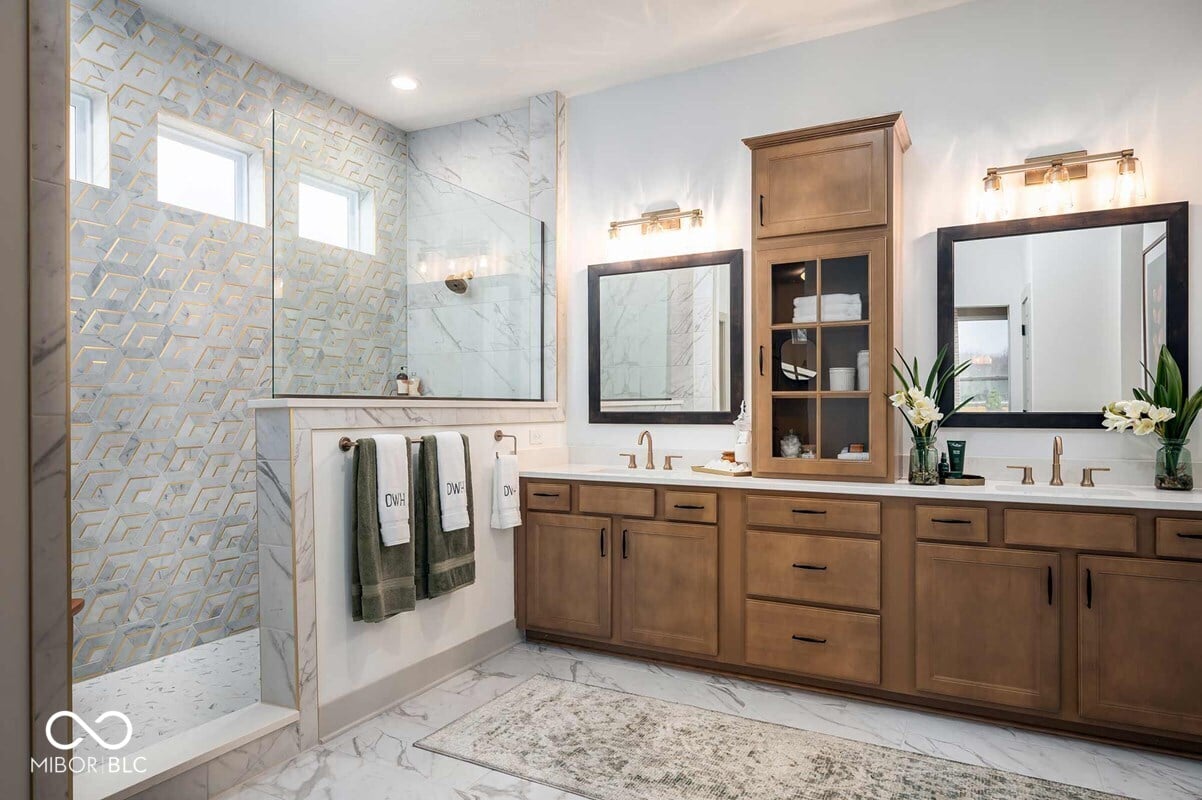 Luxurious spa-like primary bath with marble finishes.