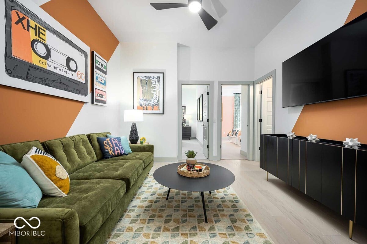 Vibrant modern family room with geometric accent walls and open layout.