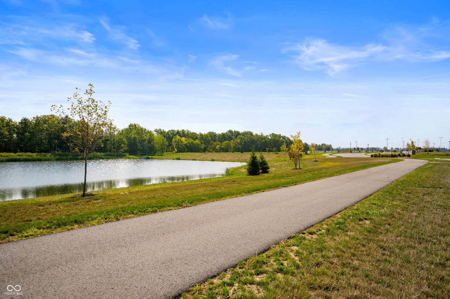 Beautiful pond-view lot with paved walking path.