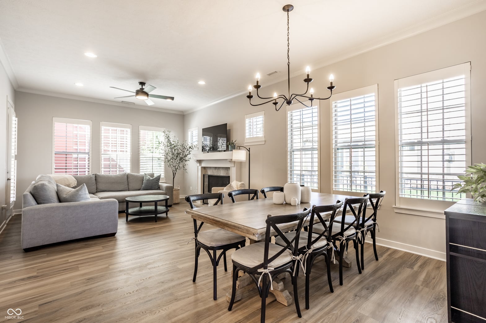 Bright open living space with fireplace and abundant natural light.