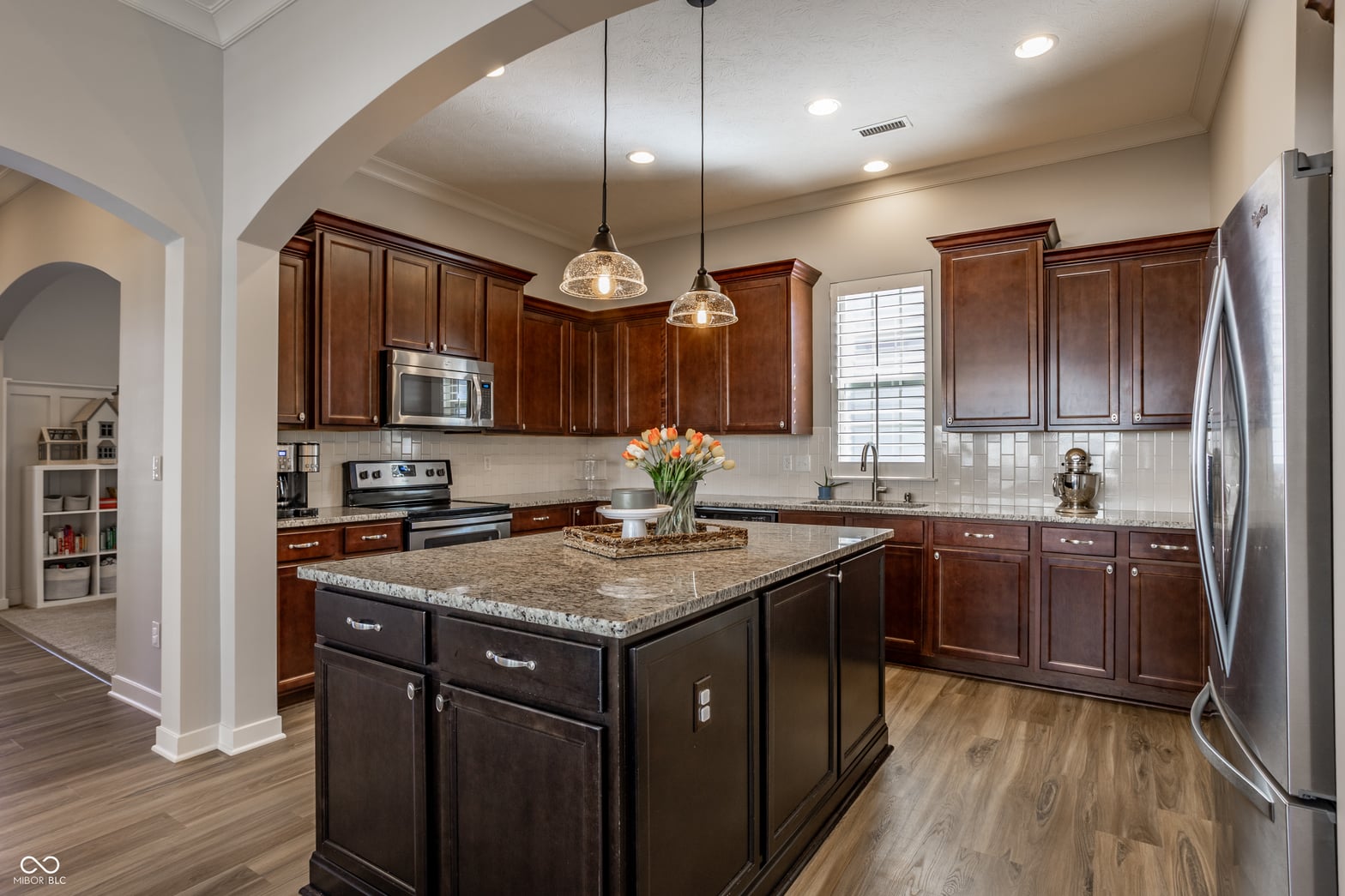 Elegant kitchen with granite island and premium stainless appliances.