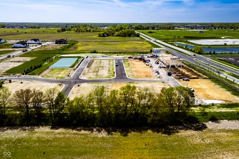 Aerial view at 430 Elite Street, Westfield, IN — New development with prime highway access and pond.