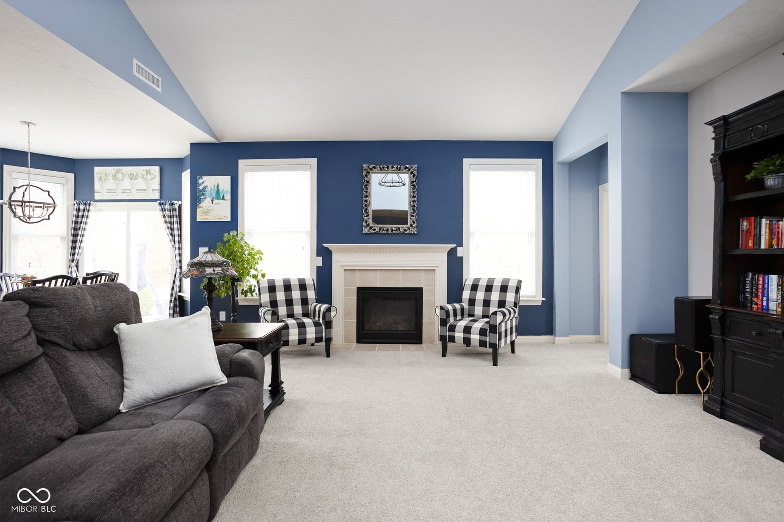 Bright family room with fireplace and built-in shelving.