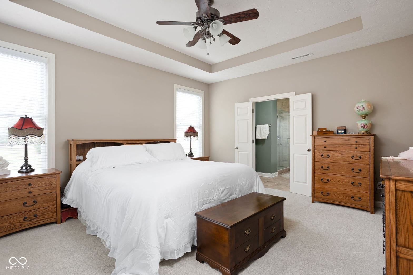 Spacious primary bedroom with ensuite and tray ceiling.