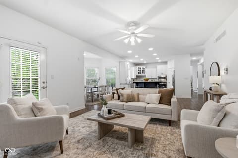 Living room at 13867 Smokey Ridge Drive, Carmel, IN — Bright, spacious living room with open kitchen layout.
