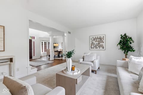Living room at 13867 Smokey Ridge Drive, Carmel, IN — Bright open-concept living area with elegant neutral design.