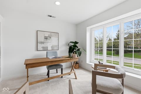 Home office at 13867 Smokey Ridge Drive, Carmel, IN — Bright, modern office with expansive windows and yard views.