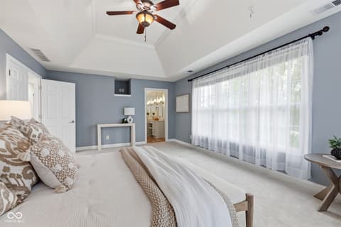 Primary bedroom at 13867 Smokey Ridge Drive, Carmel, IN — Spacious primary bedroom with vaulted ceilings and ensuite.